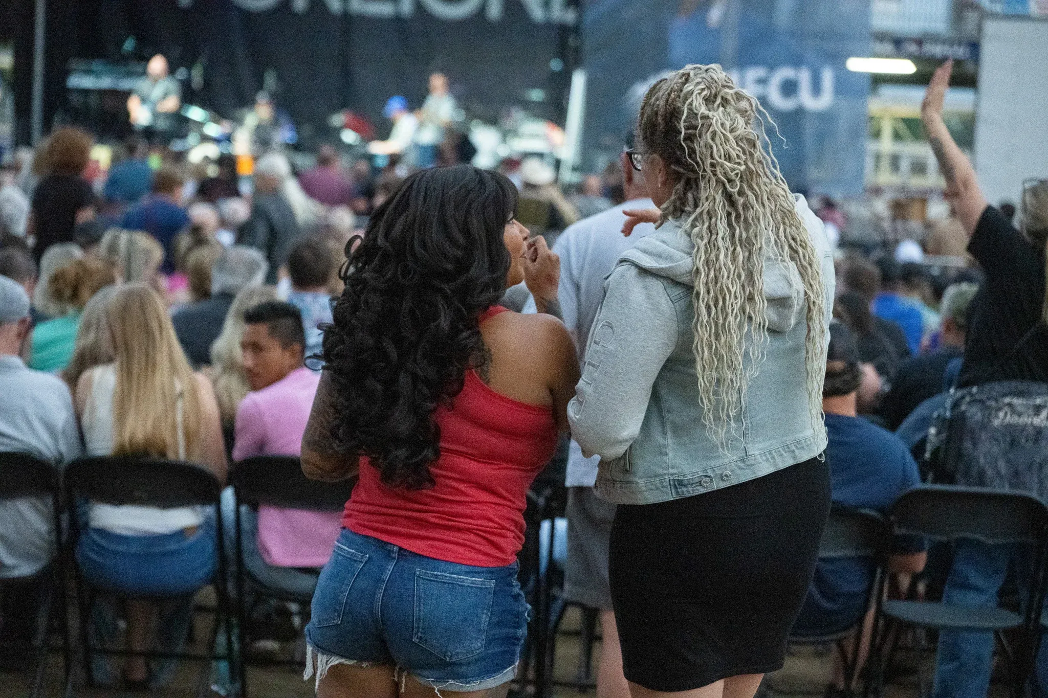 Concert attendees Chanel Finnie and Beej Dynes chat during the Foreigner concert at the Walla Walla County Fairgrounds.